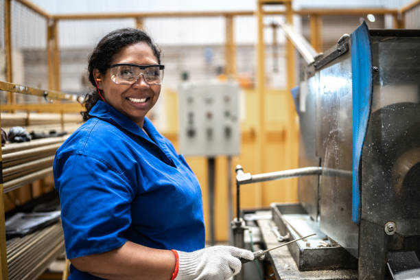 Portrait of a mid adult woman working at a factory/industry Portrait of a mid adult woman working at a factory/industry metal worker stock pictures, royalty-free photos & images