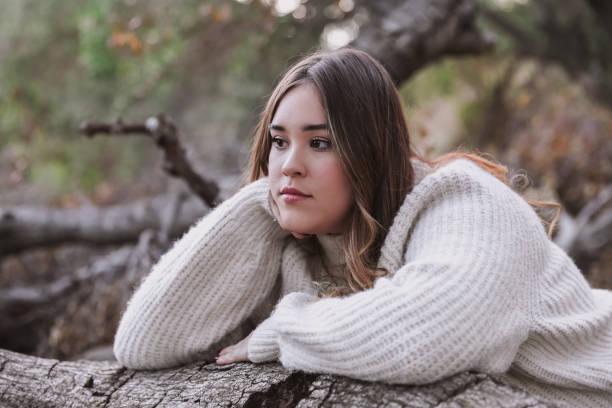 istock Female teen resting head on log 1363138109