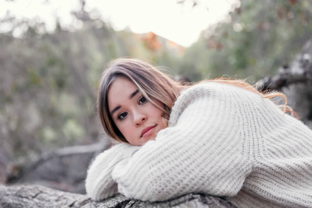istock Female teen resting head on log 1363138117
