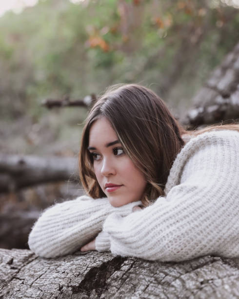 istock Female teen resting head on log 1363138132