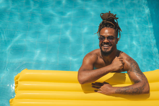 istock Man sunbathing lying on the float in the pool 1363138299