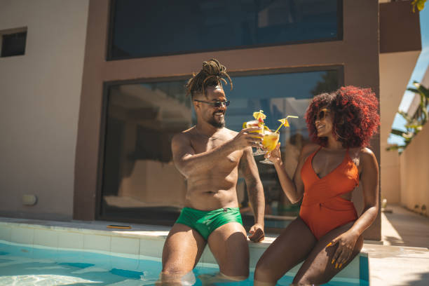 istock Afro couple having a tropical cocktail at the pool 1363138342