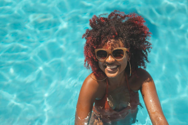 istock Young woman on vacation in the pool 1363138355