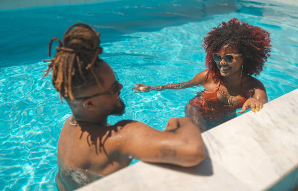 Afro couple bathing in the pool
