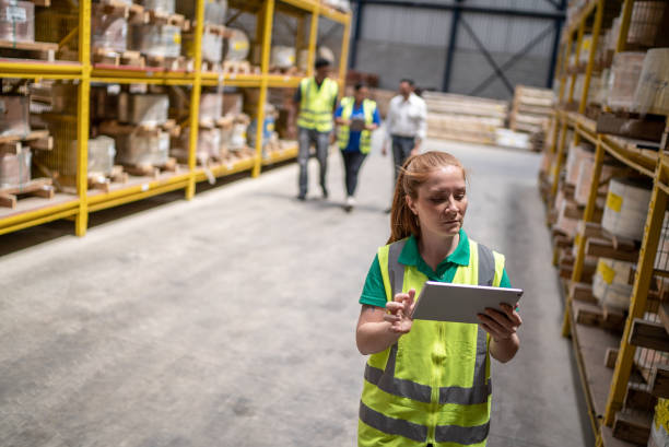 istock Woman using digital tablet taking inventory in a factory 1363138511