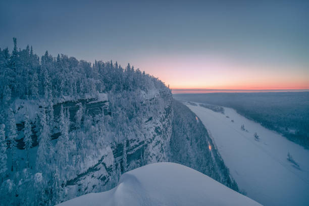 The cold January sun slowly set over the horizon, calling home the last snowmobiles. A crackling frosty night was gathering over Vishera river.