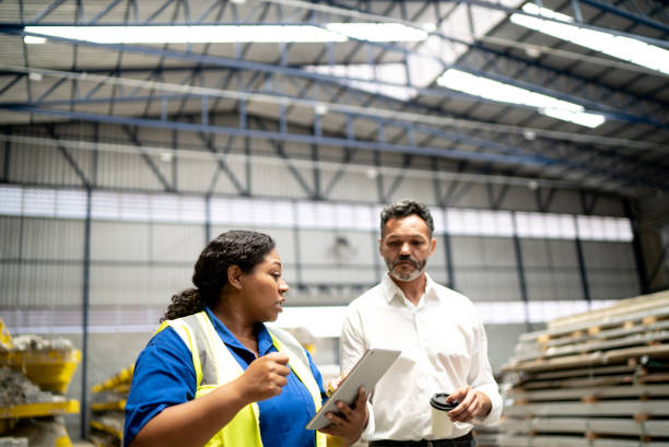 istock Manager and employee talking in a factory/industry 1363139326