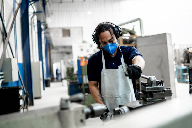istock Non-binary person working at a factory/industry - using a face mask 1363139855
