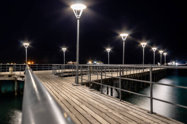 istock Illuminated sea pier at night 1363140473