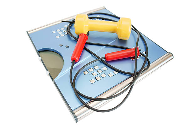 istock Dumbbells, skipping rope and scales on a white background 136314263
