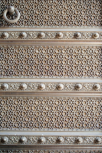 Detailed doorway panel design, part of the architecture of City Palace, Jaipur, Rajasthan, India. India displays a wealth of colour, vibrancy and imagery, none more so than in Jaipur, the Pink City, capital of Rajasthan state and named after the Maharaja who painted it pink to welcome Edward, Prince of Wales, later King Edward V11