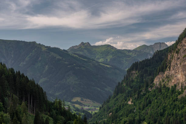 istock Summer valley with Grossarler Ache small river and blue cloudy sky 1363144694