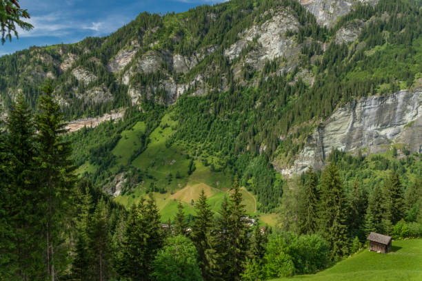 Summer valley with Grossarler Ache small river and blue white cloudy sky