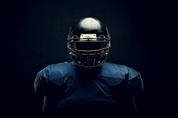 Football Player Intense portrait of a football athlete ready for game time. helmet photos stock pictures, royalty-free photos & images