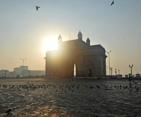 India Gate at sunrise, Colaba District, Mumbai, Maharashtra, India. India Gate is the location that welcomed the British King to India at the start of 'The Raj' and was the scene of the departure of the British in 1947. Mumbai is the second most populous city in India built over seven islands and attracts poor people from all over India who beg and scrape a subsistence living in the face of great wealth from the indigenous Indian people and global tourists