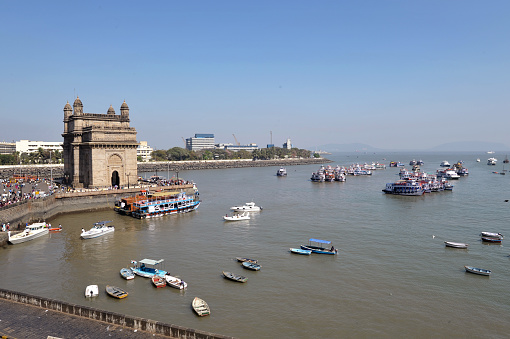 India Gate overview overlooking the bay and Indian Ocean, Colaba district, Mumbai, Maharashtra, India. Mumbai is the second most populous city in India built over seven islands and attracts poor people from all over India who beg and scrape a subsistence living in the face of great wealth from the indigenous Indian people and global tourists