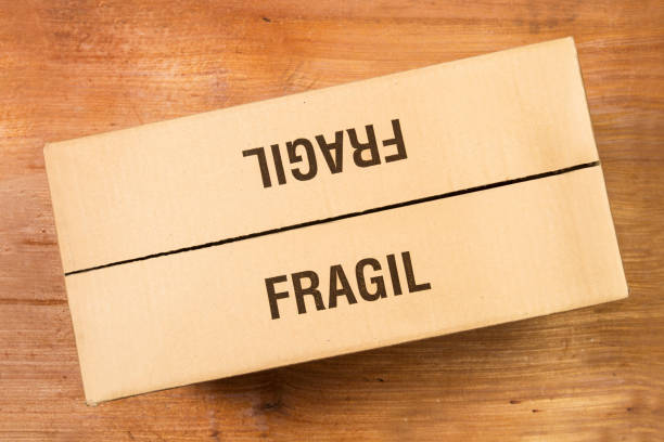 istock A cardboard box on a wooden background in a top view (fragile) 1363148622