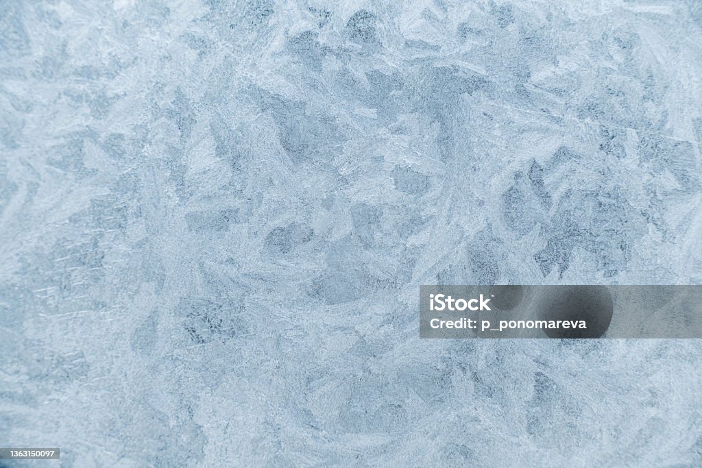 Frost pattern on a window. Frosen window texture. Abstract Stock Photo