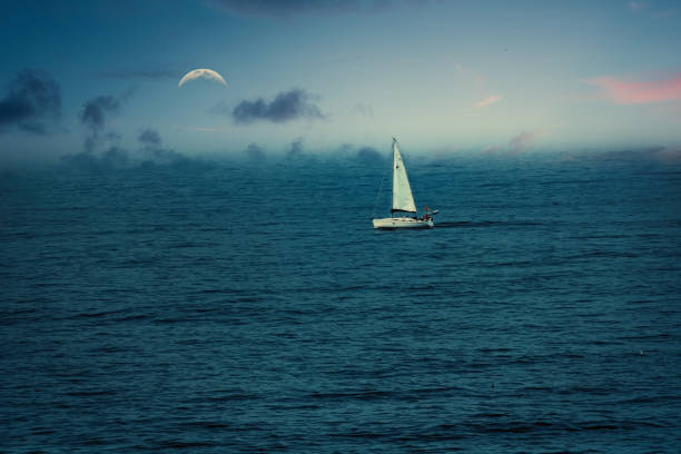istock Sailing boat with moon in the background 1363152966