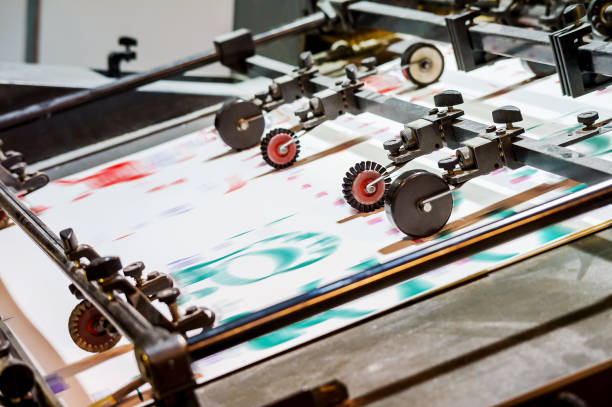 istock Printing house. Printing equipment. Machine for varnishing printed products. Processing after offset printing. 1363153075