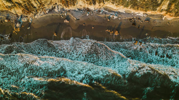 istock Aerial over waves at sunset 1363154036