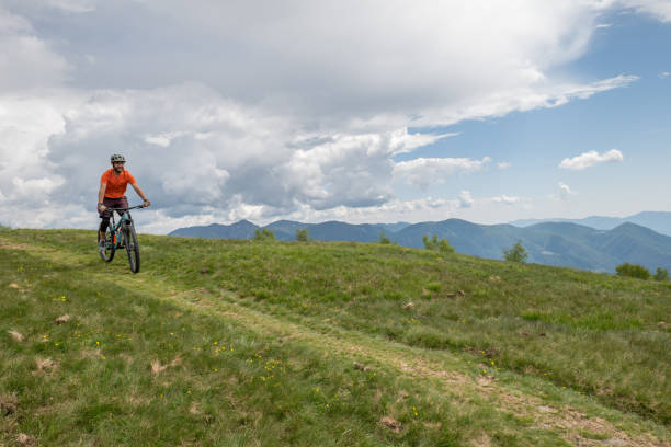 istock Man mountain biker rides along trail in Summer 1363154862