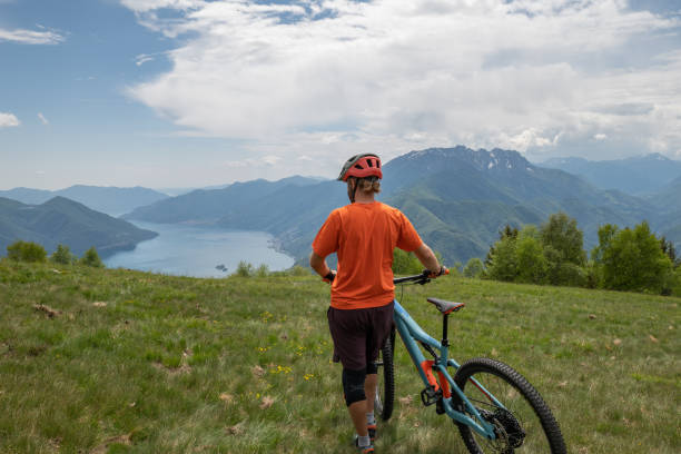 istock Man mountain biker rides along trail in Summer 1363155181