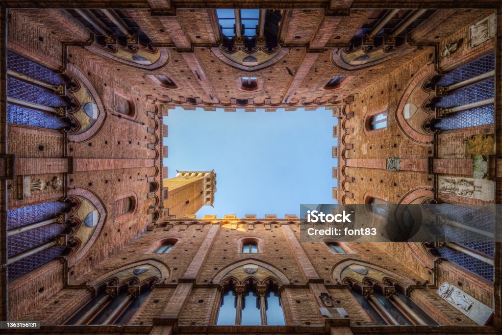 Iconic courtyard of Palazzo Pubblico (town hall) palace in Siena historic center, Tuscany, Italy Palazzo Pubblico Stock Photo