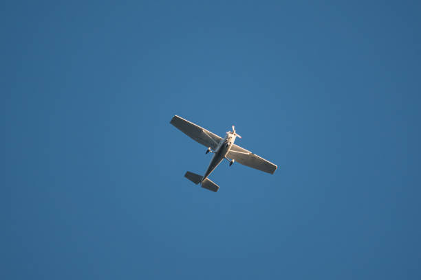 propeller plane flies in the blue cloudless sky