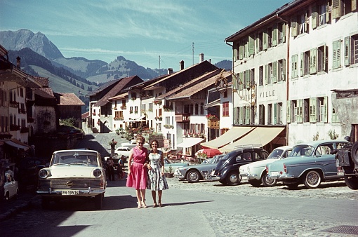 Gruyères, Canton of Friborg, Switzerland, 1960. The Marktgasse in the Swiss town of Gruyères. Furthermore: tourists, buildings and parked cars.