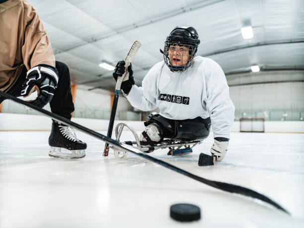 istock Latin woman and her trainer practising para hockey 1363157699