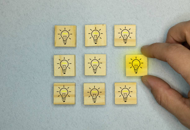 istock Innovation and Solution concept, Wooden blocks with the yellow light bulb symbol on blue background 1363166493