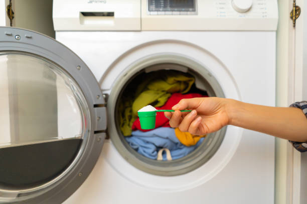 istock Female hand holds a cap with washing powder. 1363166607