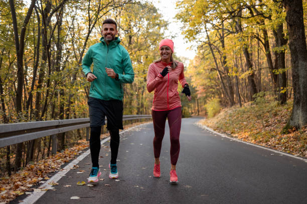 istock Happy Caucasian couple jogging in nature 1363167416