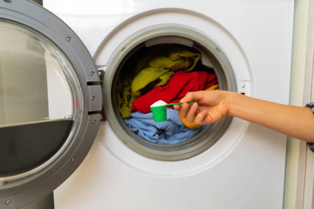 istock Female hand holds a cap with washing powder. 1363169060