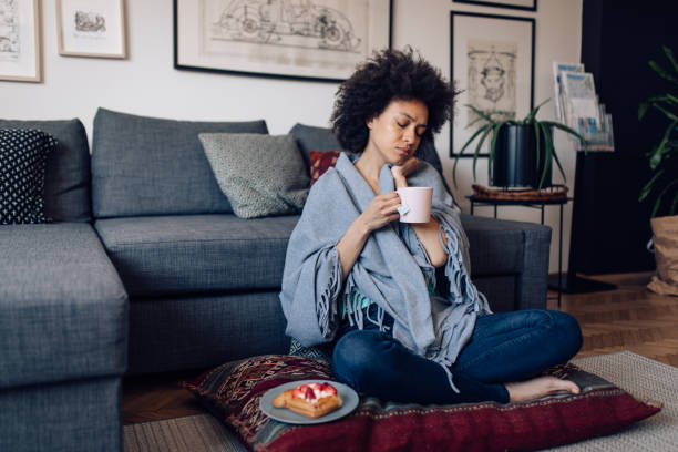 istock Woman having a flu, drinking tea at home 1363169903