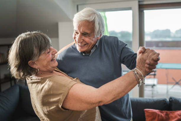 istock Elderly couple dancing at home 1363170012