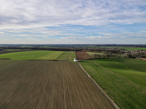Areal view of agricultural field against cloudy sky in south of Belgium.