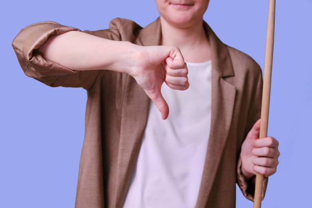 istock Woman teacher with thumb down gesture on studio blue background, copy space 1363177784