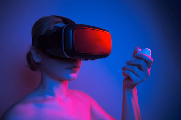 istock Woman wearing VR glasses and spending time controlling with joystick 1363179637
