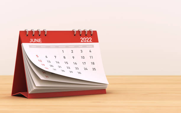2022 Red June Calendar Standing on Wooden Floor stock photo 2022 Red June Calendar Standing on Wooden Floor Table and Wall Depth of Field stock photo june file stock pictures, royalty-free photos & images