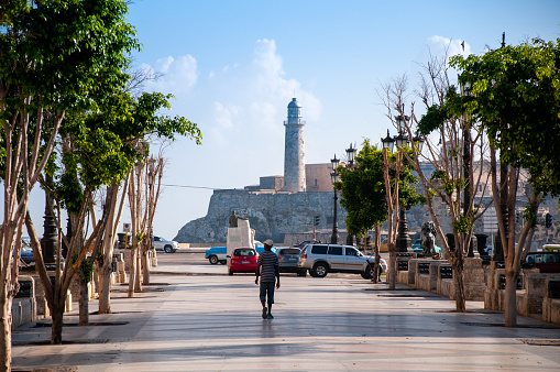 View of the central sidewalk in the Paseo del Prado with the Morro Lighthouse in the background, this is one of the most important avenues of Old Havana. Havana Cuba. May 12, 2015.