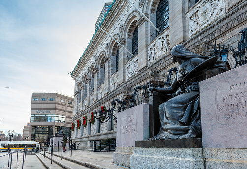 Boston, USA - December 23, 2021: View of the main entrance to the McKim Building of the Boston Public Library. The Boston Public Library McKim Building, from 1895, in Copley Square contains the library's research collection, exhibition rooms and administrative offices.