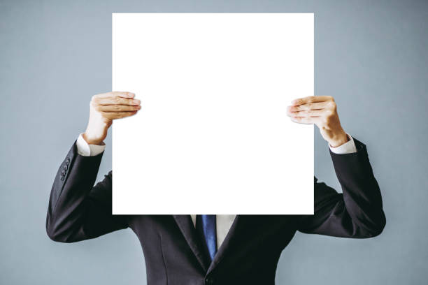 istock Businessman hiding face with white board 1363188484