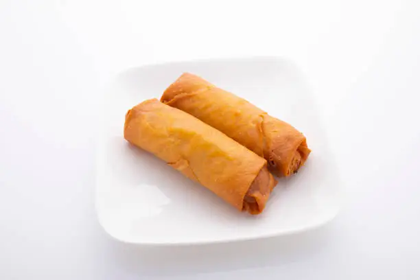Spring rolls served on a white plate