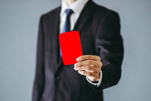 istock Businessman holding a red card 1363195909