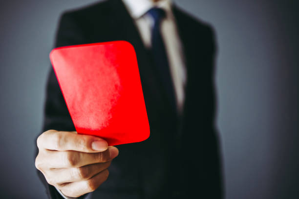 istock Businessman holding a red card 1363195913
