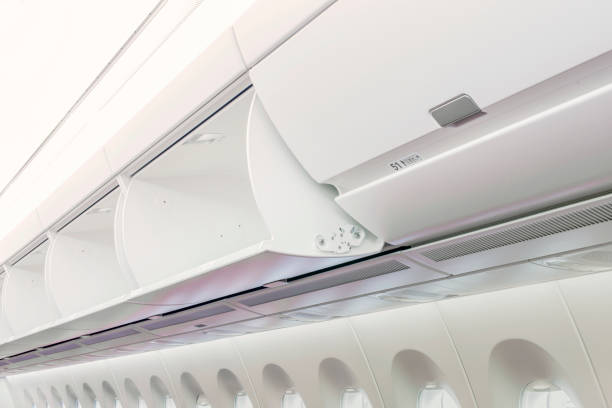 istock Carry-on luggage in overhead storage compartment on commercial airplane. 1363198862