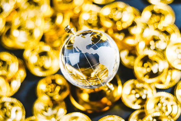 istock Globe and shining gold coins 1363198945
