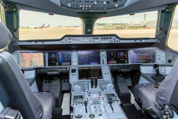 the image of cockpit interior and airplane cockpit view and blur background airport building with traffic control tower and airplanes on runway - cockpit airplane autopilot dashboard imagens e fotografias de stock